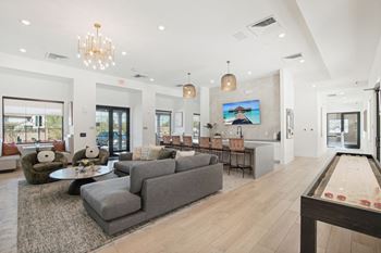 A living room with couches and chairs and a dining room table